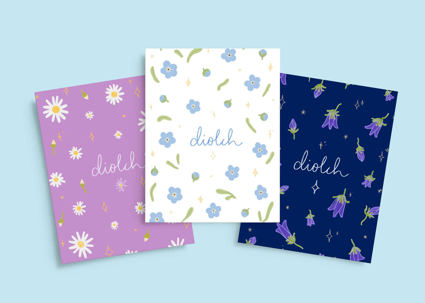 Set of 3 Welsh ‘Diolch’ thank you cards with hand-drawn spring flowers and stars, featuring Daisies, Forget-Me-Nots, and Bluebells. Comes with recycled kraft envelopes.