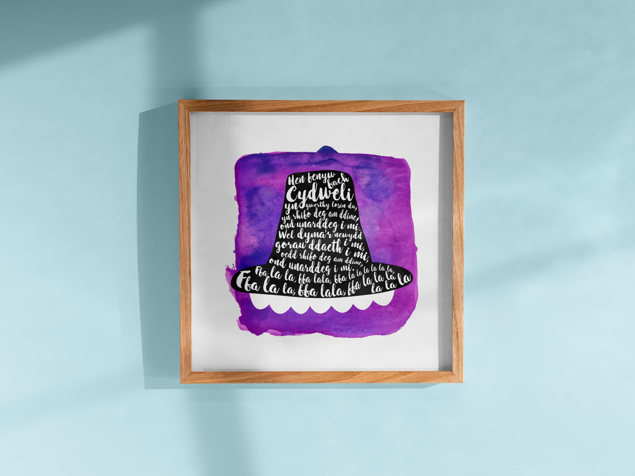 A tribute to one of Wales’ most beloved songs, this print features Hen Fenyw Bach lyrics in a Het Gymreig 'Welsh Hat' pruple watercolour design.