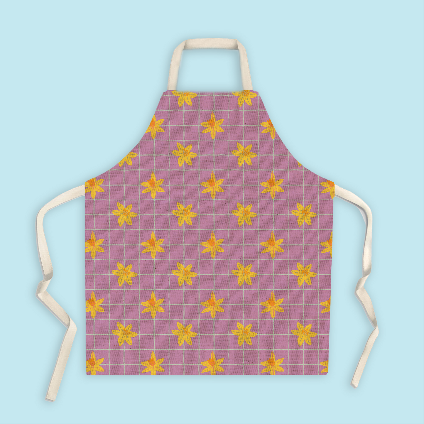 Fair trade cotton apron with hand-drawn daffodils and blue grid pattern in purple