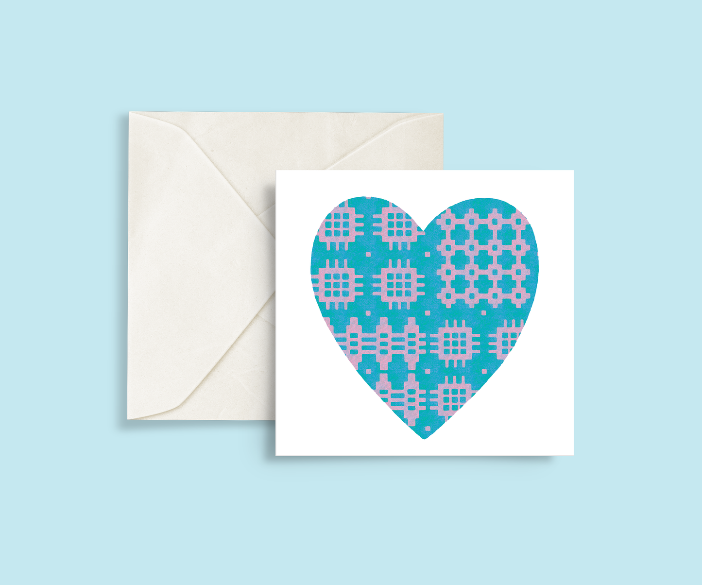 A minimalist card featuring a blue and lilac Welsh blanket patterned heart in the centre.