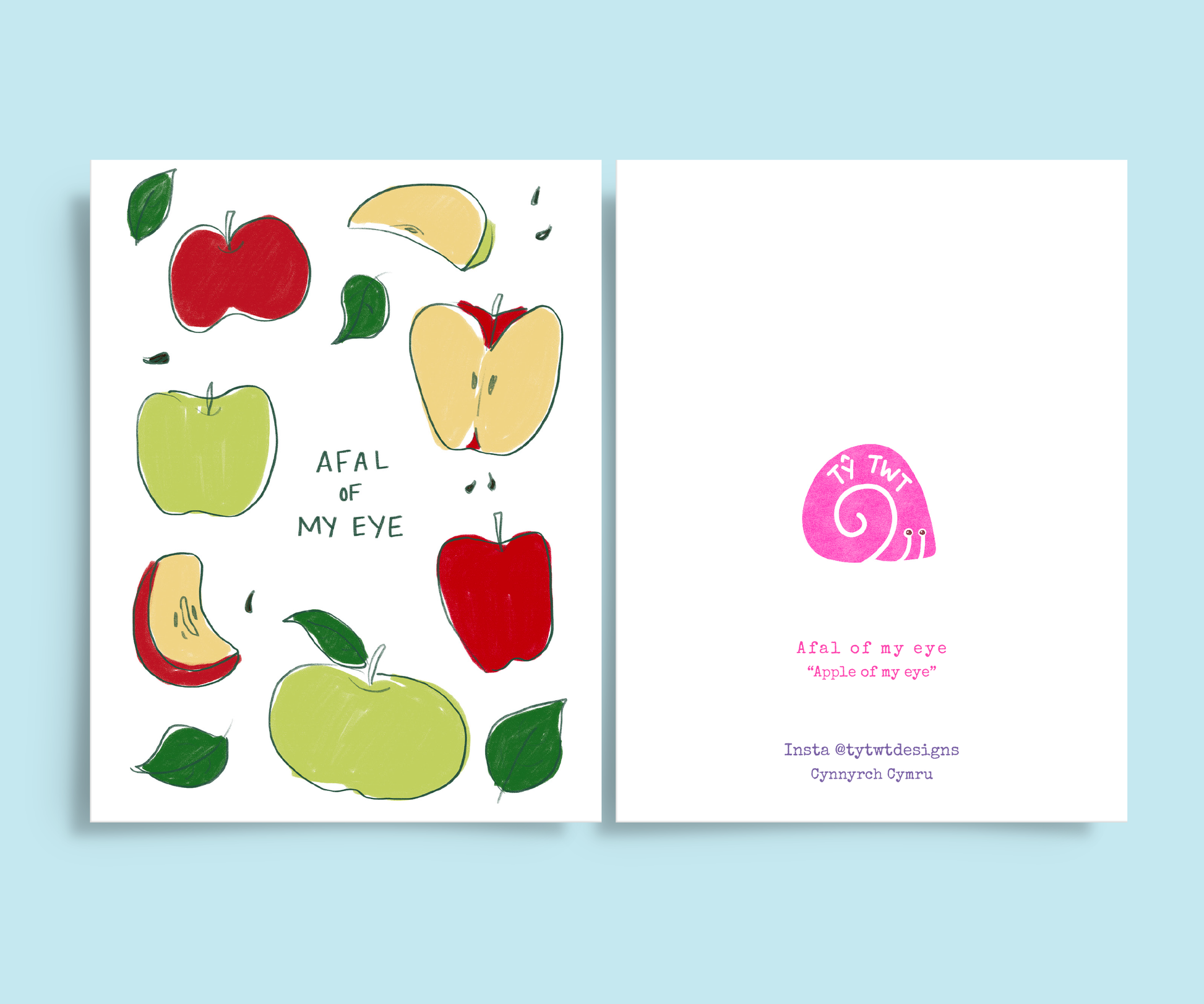 Light blue background and front and back of greeting card. Left side is apples illustration with handwritten Afal of my eye and left is Welsh to English translation in typewriter font. Instagram @tytwtdesigns made in Wales