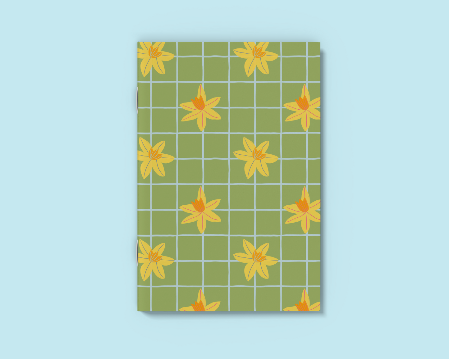 A6 green notebook with hand drawn daffodil and blue grid