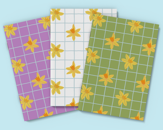 Set of three A6 daffodil notebooks in white, green, and purple.