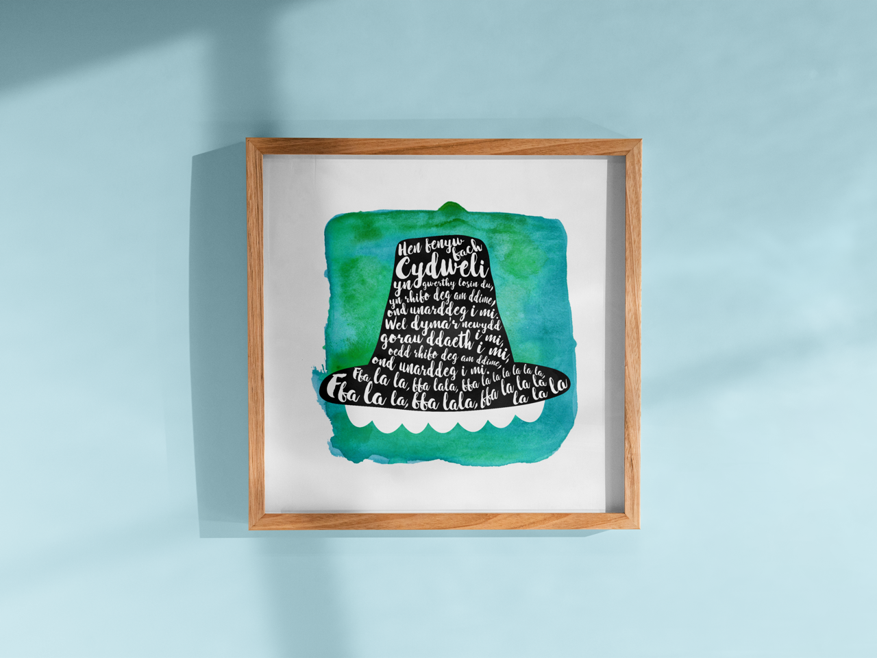 A tribute to one of Wales’ most beloved songs, this print features Hen Fenyw Bach lyrics in a Het Gymreig 'Welsh Hat' blue watercolour design.
