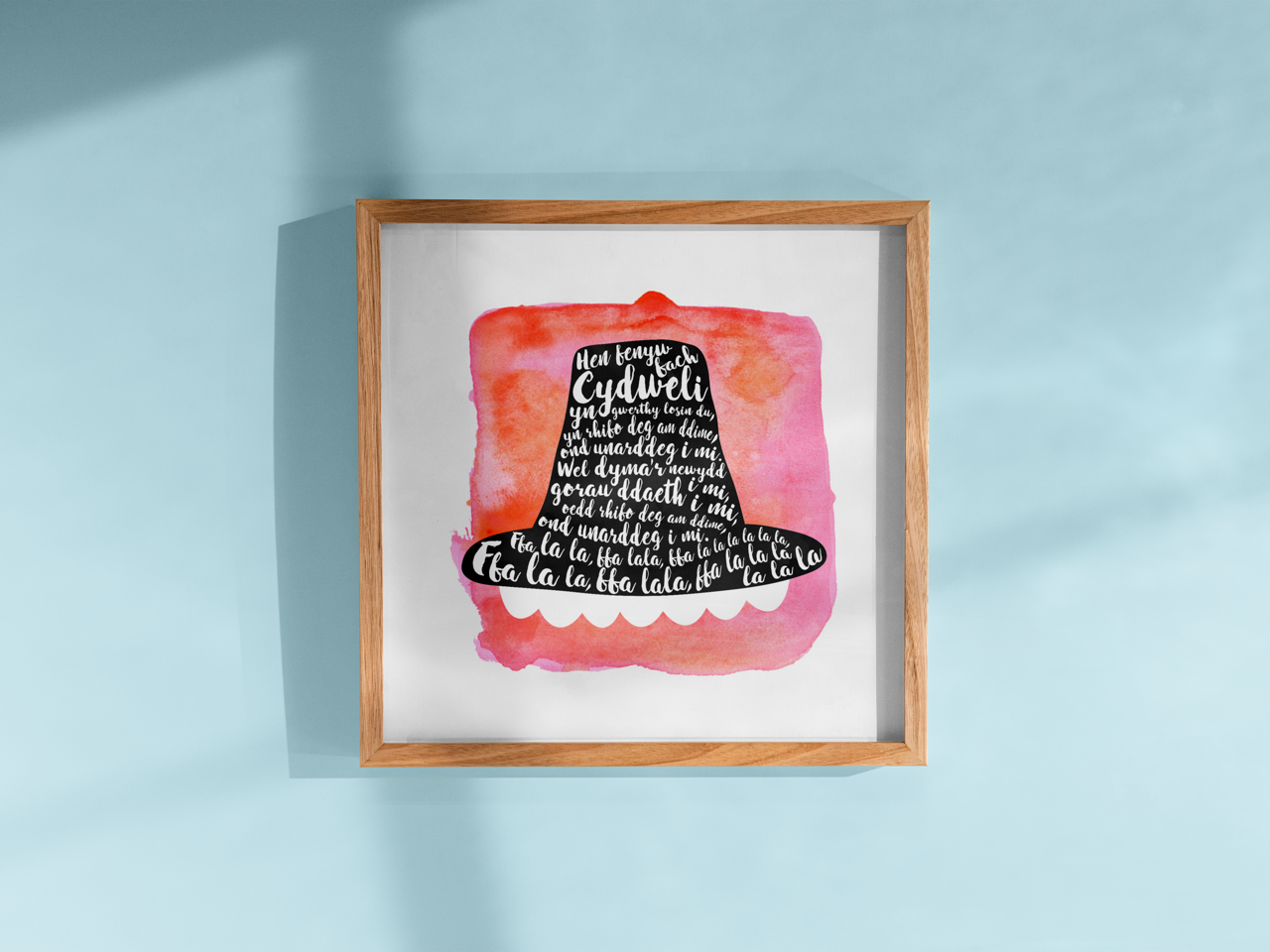 A tribute to one of Wales’ most beloved songs, this print features Hen Fenyw Bach lyrics in a Het Gymreig 'Welsh Hat' red watercolour design.