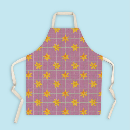 Fair trade cotton apron with hand-drawn daffodils and blue grid pattern in purple