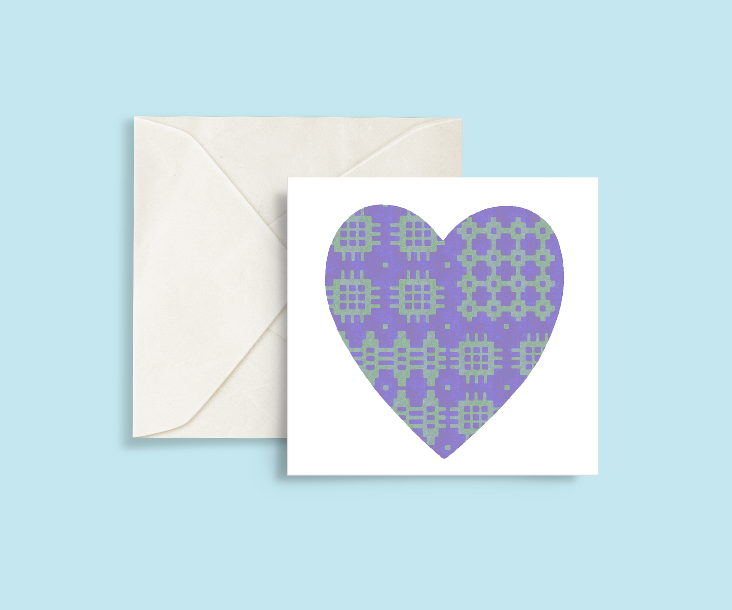 A minimalist card featuring a purple and green Welsh blanket patterned heart in the centre.