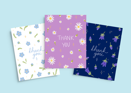 Set of 3 Welsh thank you cards with hand-drawn spring flowers and stars, featuring Daisies, Forget-Me-Nots, and Bluebells. Comes with recycled envelopes.