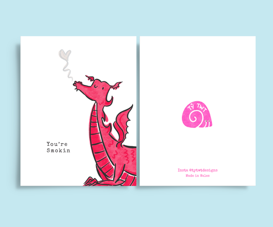 Featuring a hand illustrated print of a Welsh red dragon, puffing smoke with typewriter text reading 'you're smokin'" On back of card reads  Instagram @tytwtdesigns made in Wales